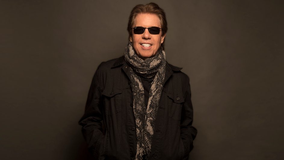 George Thorogood standing with a smile on his face
