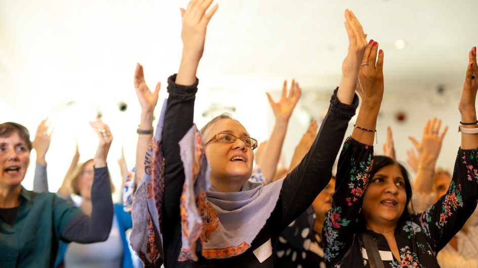 Singing and Well being participants with hands in the air